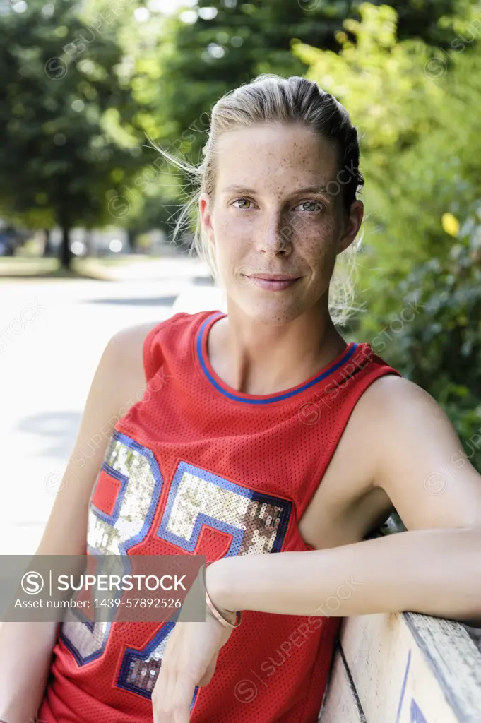 Portrait of female basketball player taking a break in park