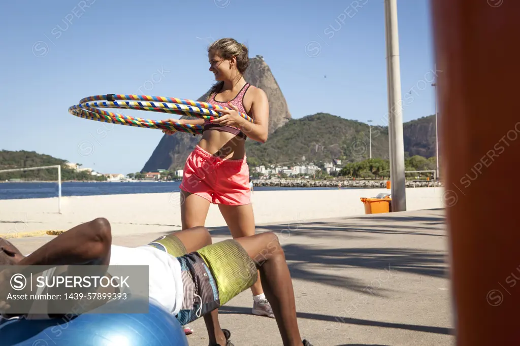 Young woman holding plastic hoops, Rio de Janeiro, Brazil