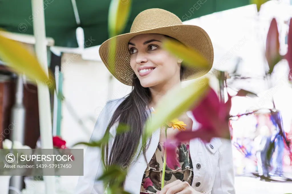 Young female tourist at flower market stall, Split, Dalmatia, Croatia