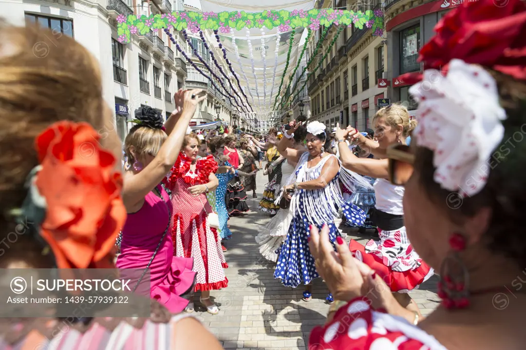 Women dancing at a vibrant street festival