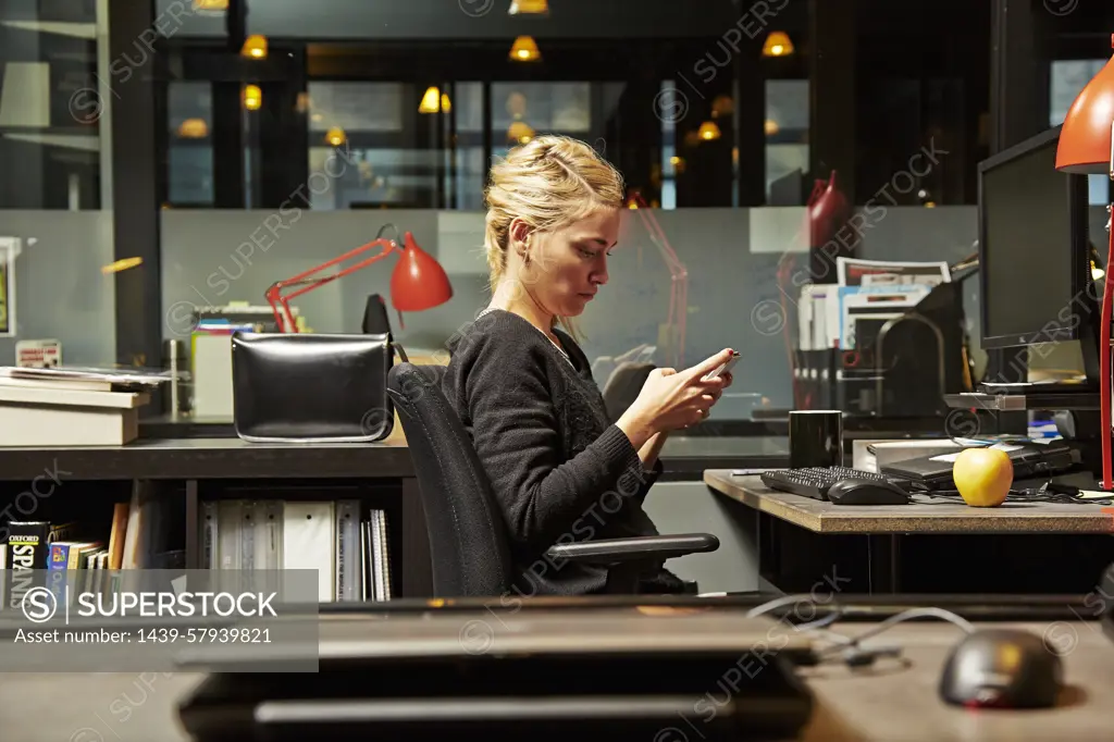 Focused professional working late in a modern office.