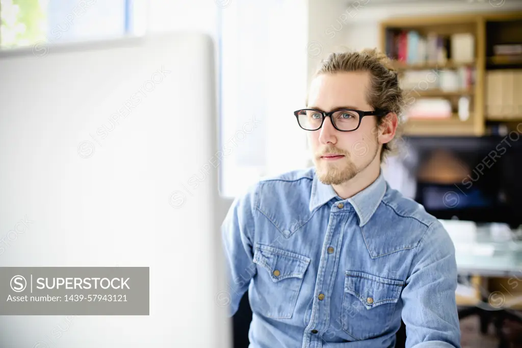 Young professional working intently at his computer