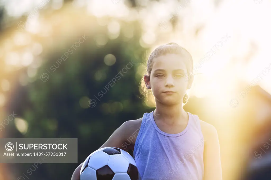 Young soccer player ready for the game at sunset