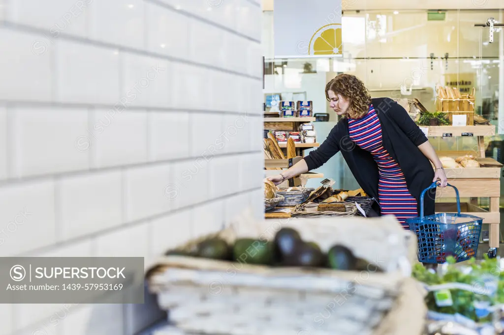 A woman shopping for groceries in a welllit store.