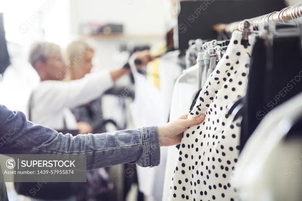 Shopping for the perfect outfit among racks of clothes