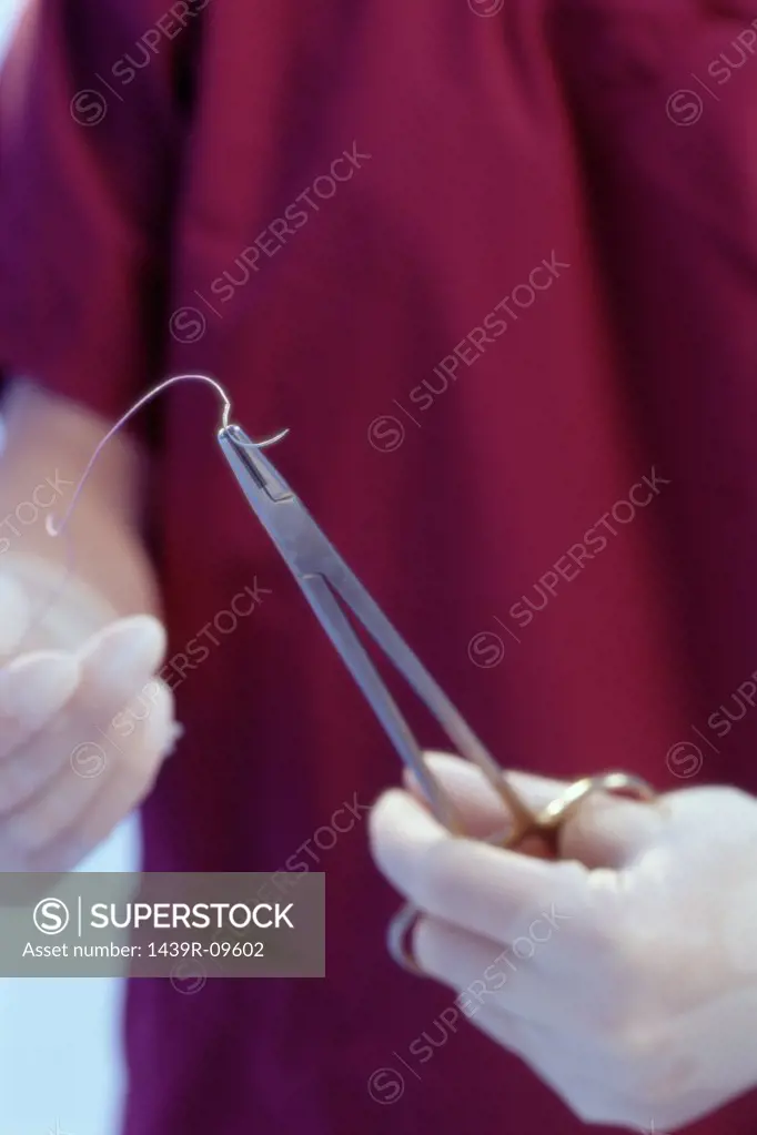 Surgeon preparing stitches