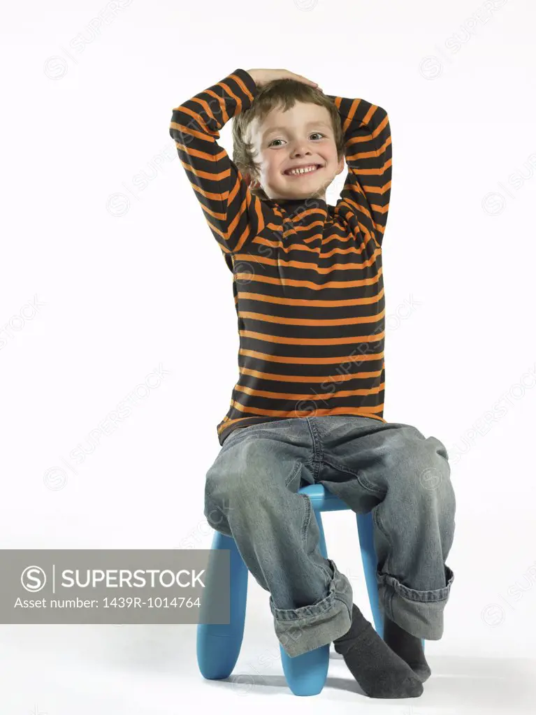 Boy sitting on stool