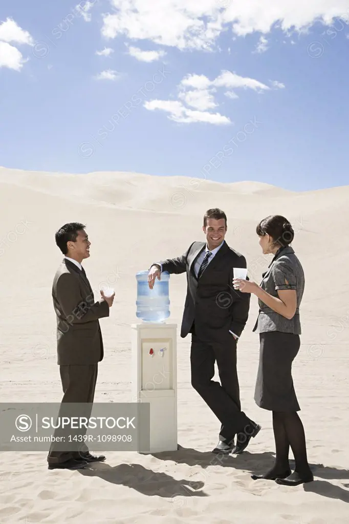 People around water cooler in the desert