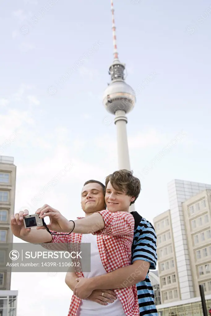 A gay couple photographing themselves