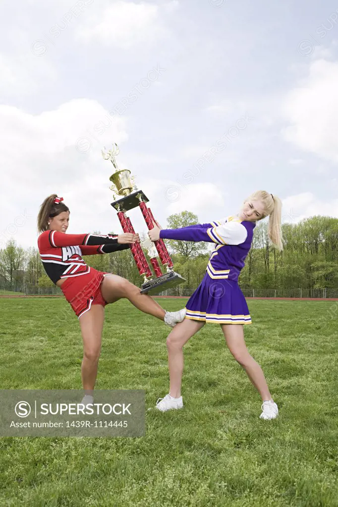 Cheerleaders fighting over trophy