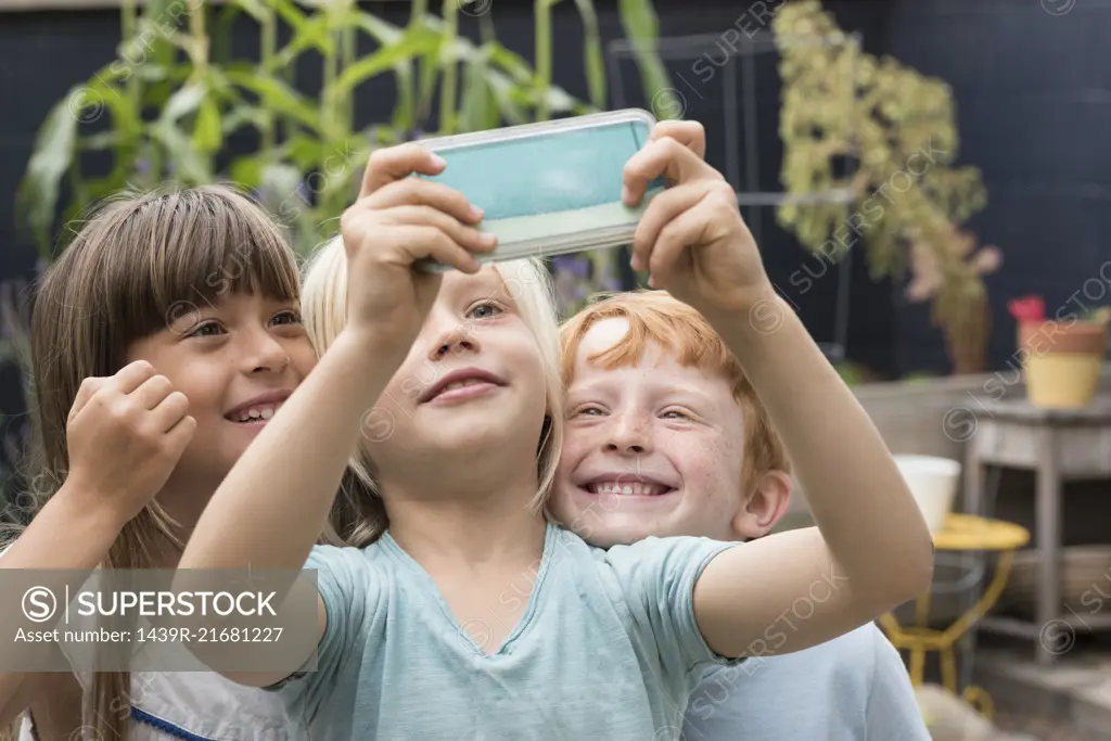 Smiling children taking selfie