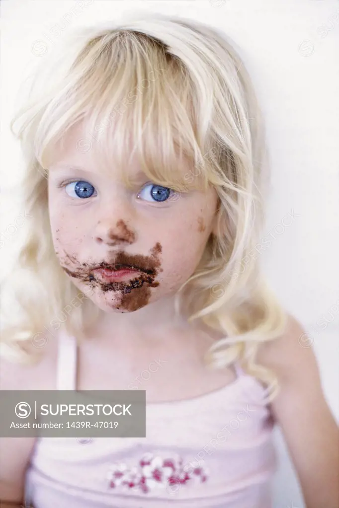 Girl with chocolate on her face  