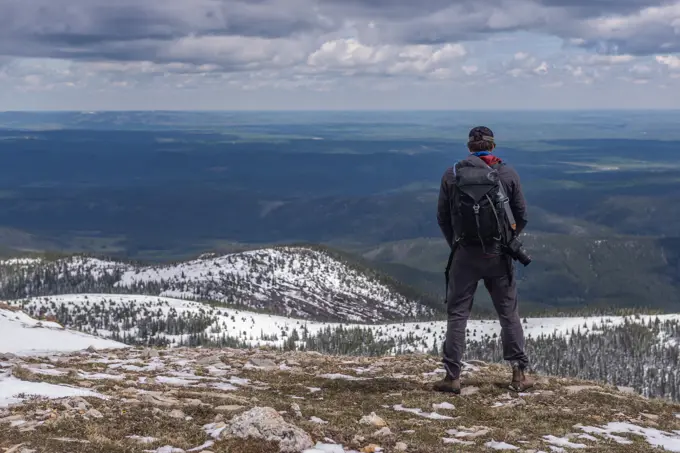 Hiker on top of mountain range, Calgary, Canada