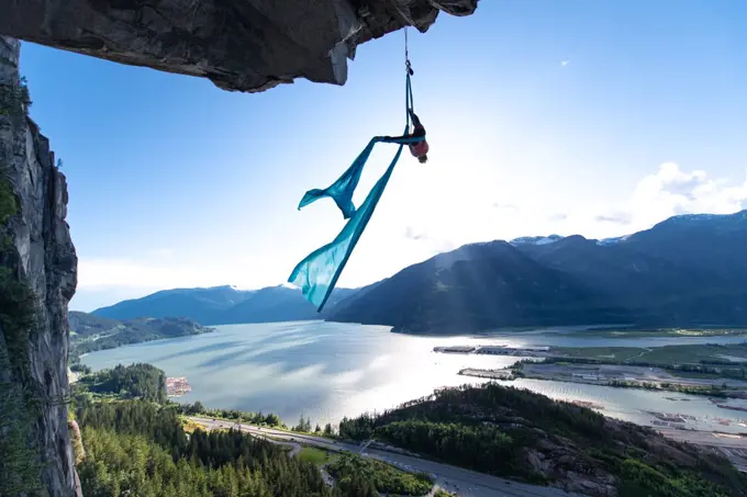 Woman on aerial silks on the Stawamus Chief in Squamish, British Columbia, Canada