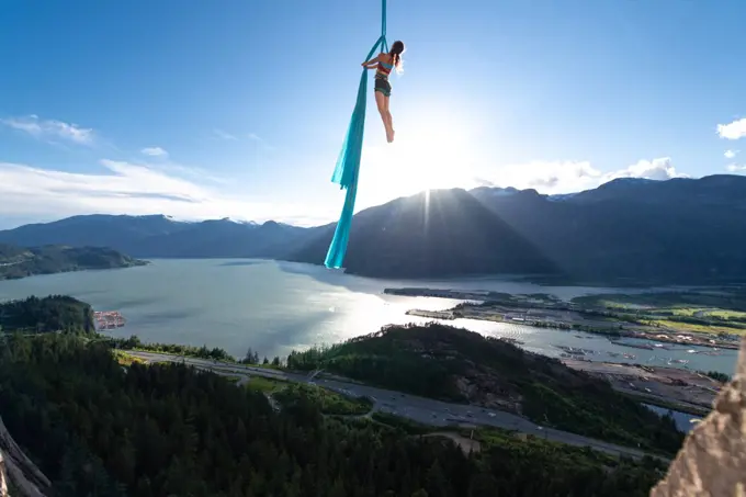 Woman on aerial silks on the Stawamus Chief in Squamish, British Columbia, Canada