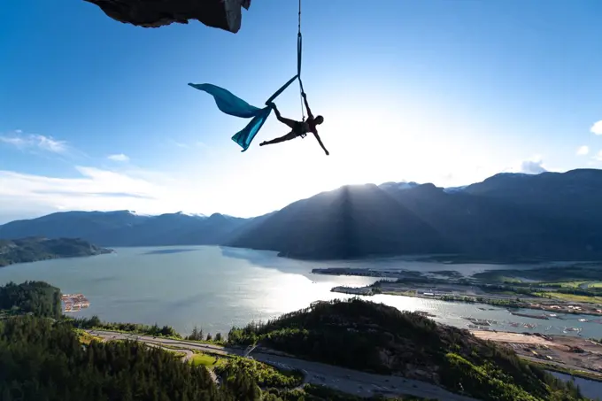 Woman on aerial silks on the Stawamus Chief in Squamish, British Columbia, Canada