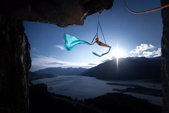 Woman on aerial silks on the Stawamus Chief in Squamish, British Columbia, Canada