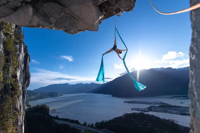 Woman on aerial silks on the Stawamus Chief in Squamish, British Columbia, Canada