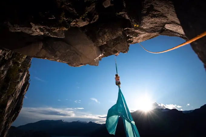 Woman on aerial silks on the Stawamus Chief in Squamish, British Columbia, Canada