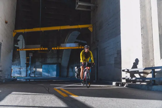 Cyclist emerging from tunnel, Ontario, Canada