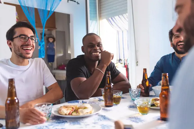 Male friends socialising with food and beer