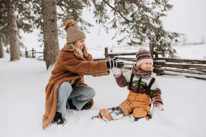 Canada, Ontario, Mother and daughter playing in snow