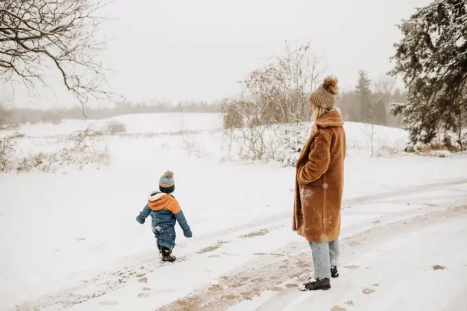 Canada, Ontario, Mother and son on snowy road