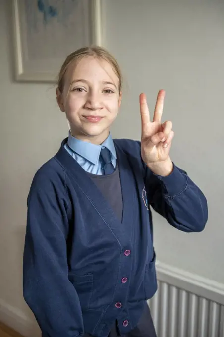 UK, Surrey, Portrait of smiling girl in school uniform