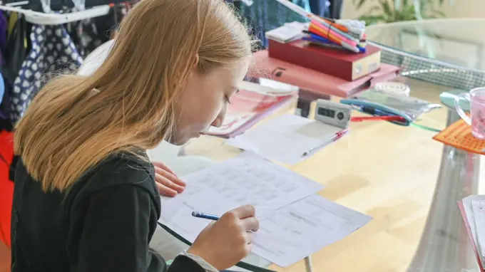 UK, Surrey, Girl doing homework