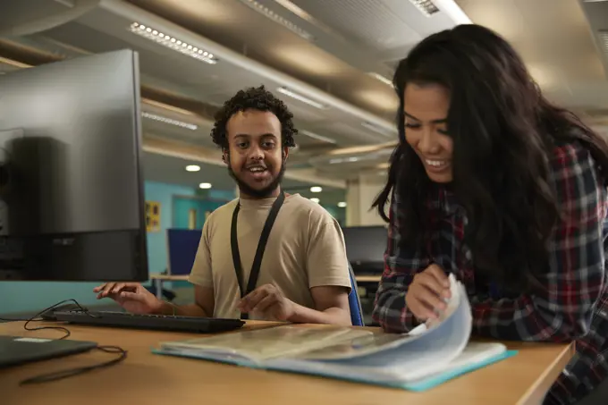 Students using computer in library