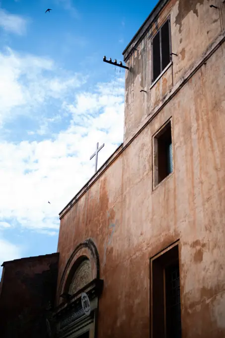 Italy, Rome, Church facade with cross against sky