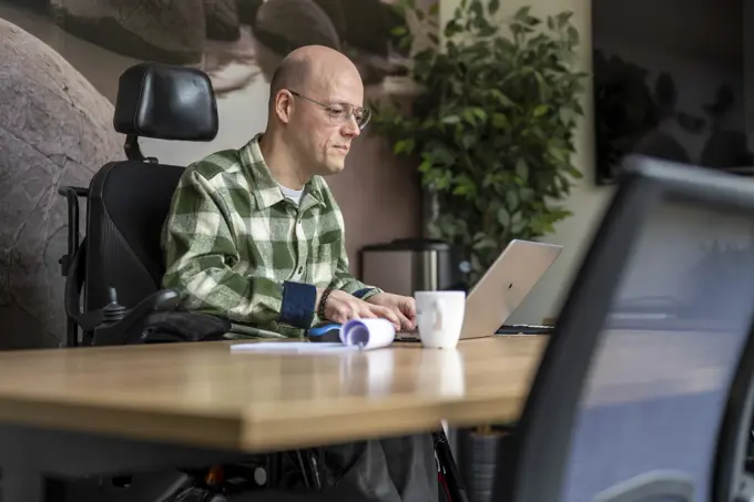 Disabled businessman working on his computer.