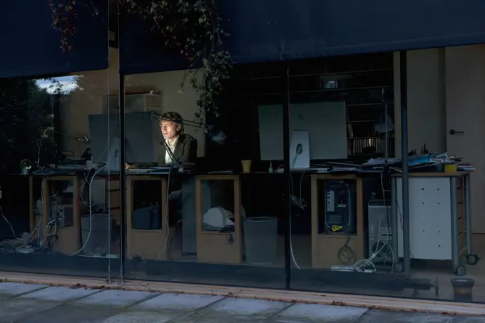 Young man at home working late on computer