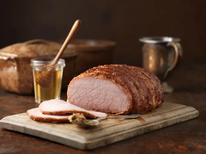 Christmas dinner. Honey and wholegrain mustard gammon on chopping board