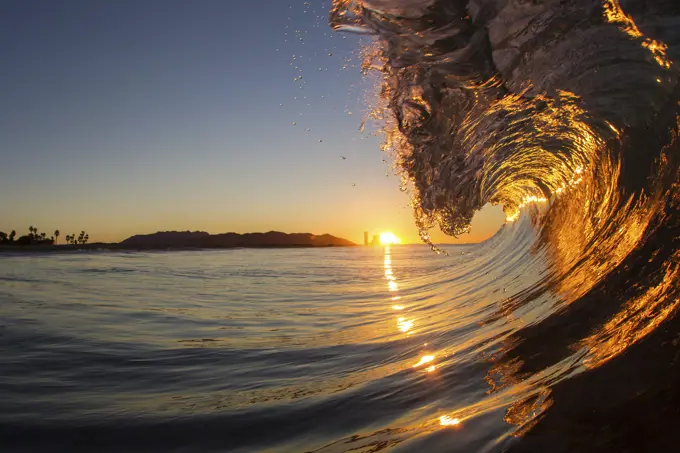 Barrelling wave at sunset, Hawaii