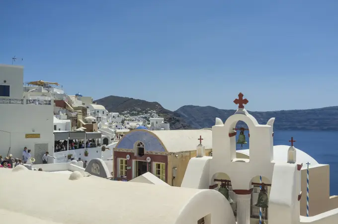 View of rooftops and whitewashed church, Oia, Santorini, Greece