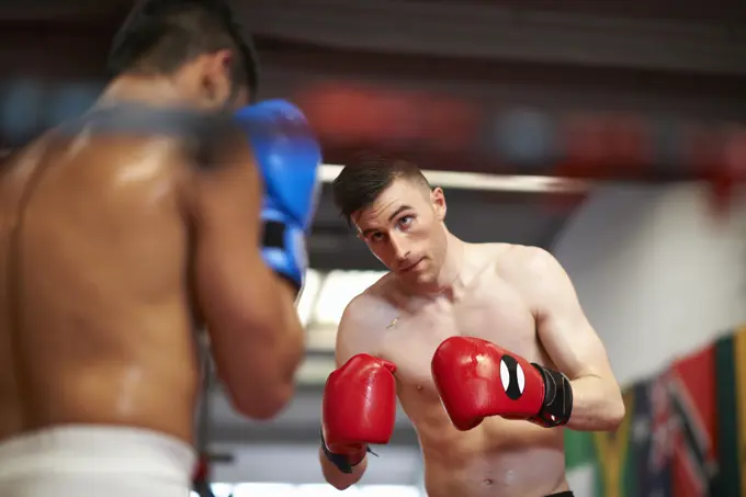 Two boxers sparring in boxing ring