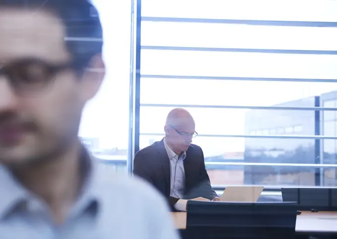 Window view of businessmen working in office