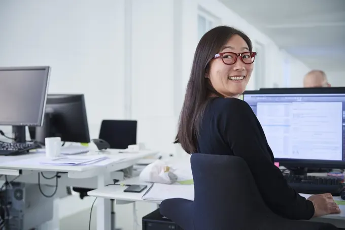 Woman working in office, using computer