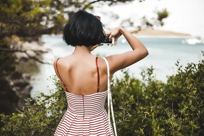 Woman taking photograph of coast, Koralat, Zagrebacka, Croatia