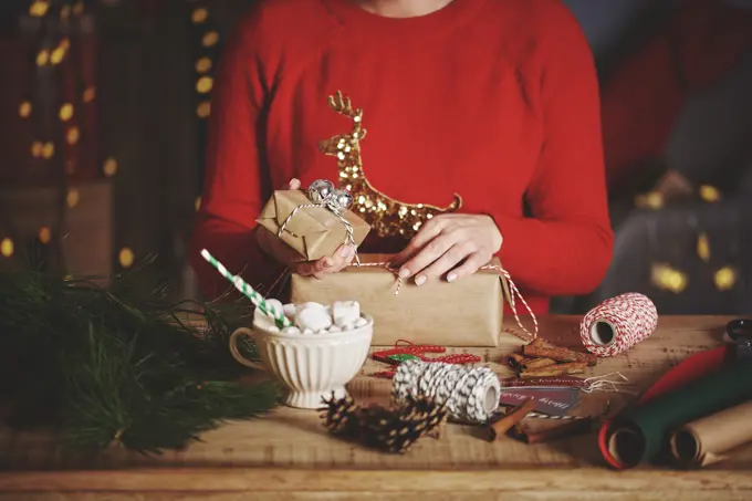 Woman wrapping christmas gifts