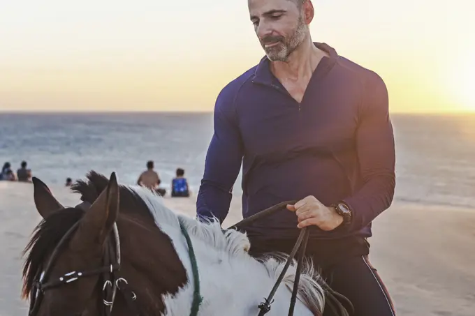 Man riding horse on beach, Jericoacoara, Ceara, Brazil, South America