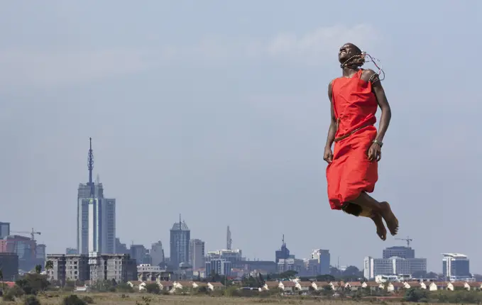 Masai warrior jumping in mid air during traditional dance, Nairobi, Kenya, Africa