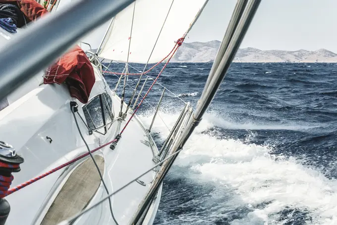 Aboard view of yacht sailing through ocean waves near coast, Croatia