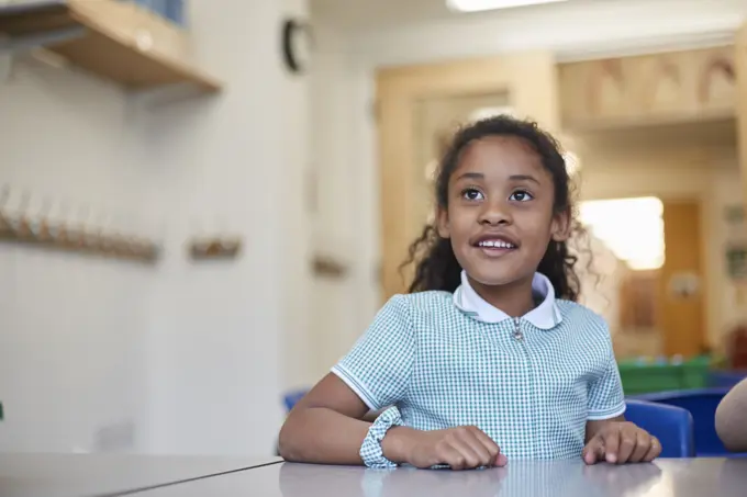 Young girl smiling in classroom environment