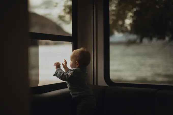 Baby looking out window of motorhome, Wanaka, Taranaki, New Zealand