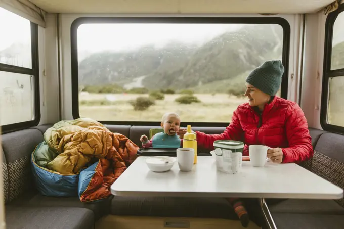 Mother feeding baby in motorhome, Wanaka, Taranaki, New Zealand