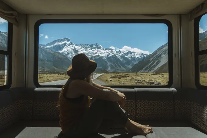 Woman enjoying view from inside motorhome, Wanaka, Taranaki, New Zealand