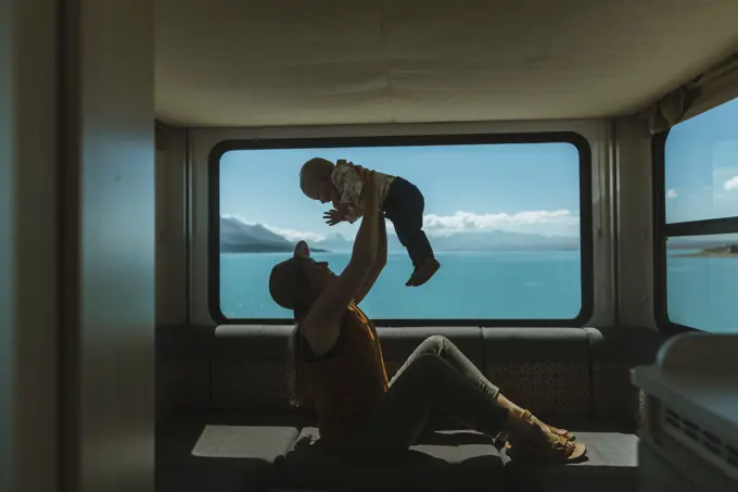 Mother playing with baby in motorhome, Wanaka, Taranaki, New Zealand