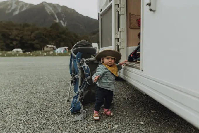 Baby hiker posing beside motorhome, Queenstown, Canterbury, New Zealand